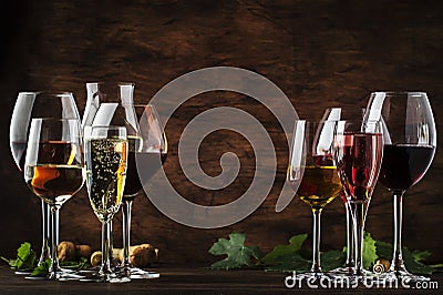 Wine tasting, still and sparkling wines. Red, white wine, rose and champagne ÑˆÑ‚ assortment in wine glasses on vintage wooden Stock Photo